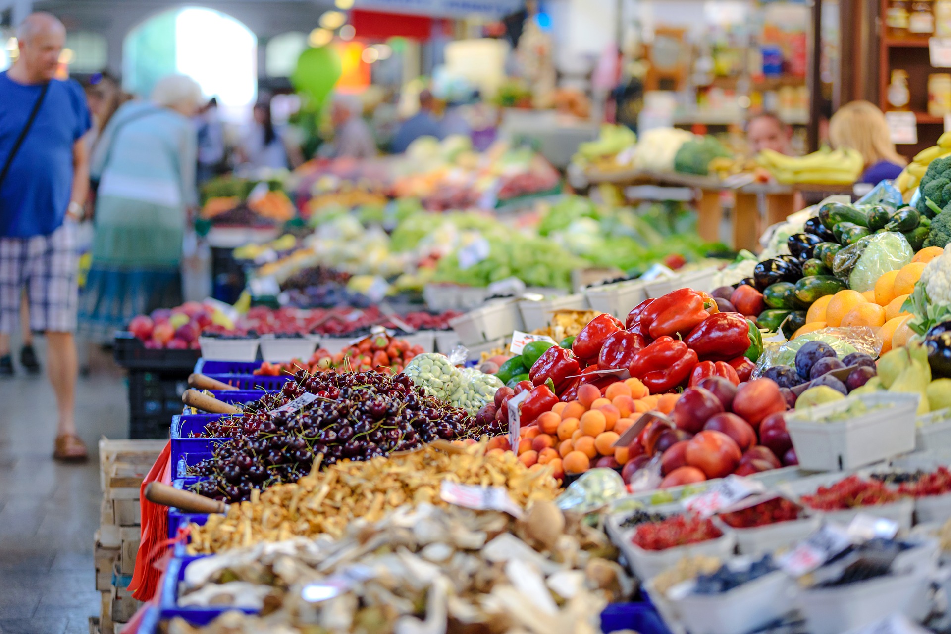 A view of a market stall with lots of colorful fruit and vegetables.