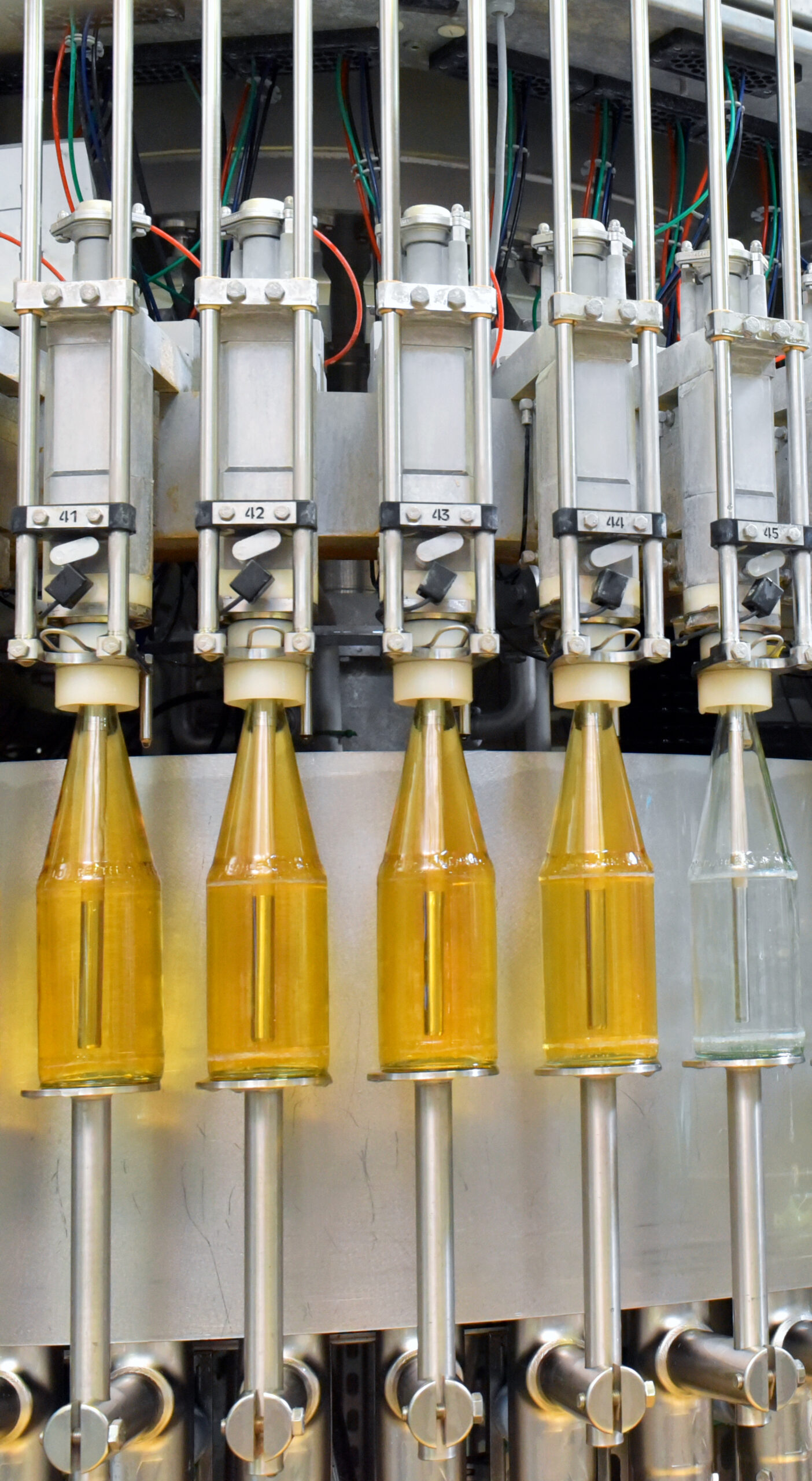 apple juice in glass bottles in a factory for the food industry bottling and transport